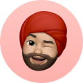 Man with red turban winking and tongue out