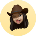 Woman with long hair wearing a brown hat, tongue out