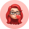 Red-haired woman with glasses and neutral expression