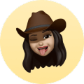 Woman with long hair wearing a brown hat, tongue out