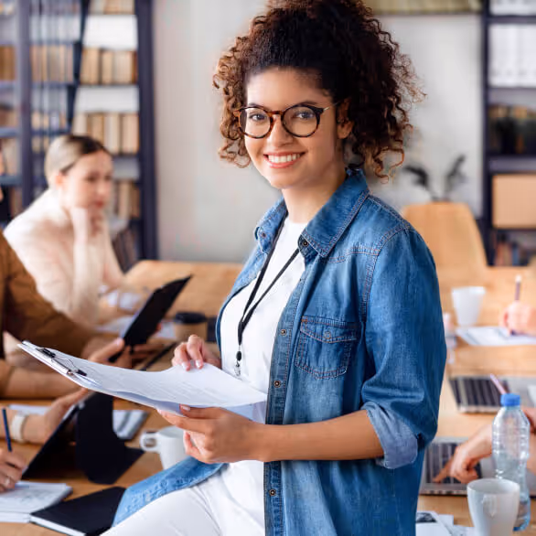 Woman with smiling with clipboard and paperwork