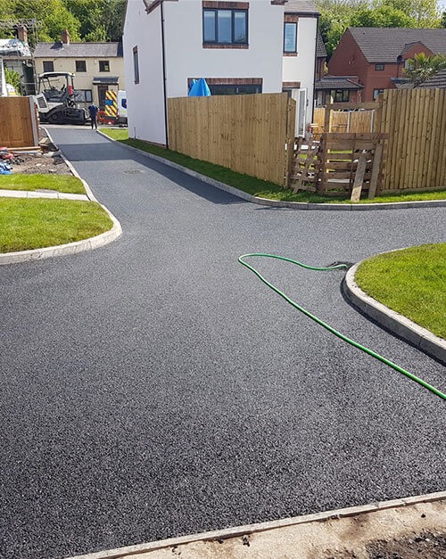 Newly laid asphalt road on a new build housing estate