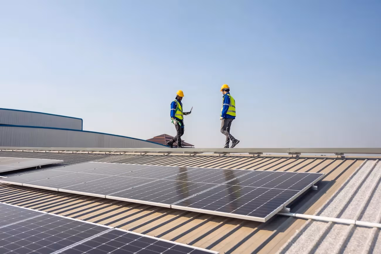 Renewable energy engineer approving solar panel installation.