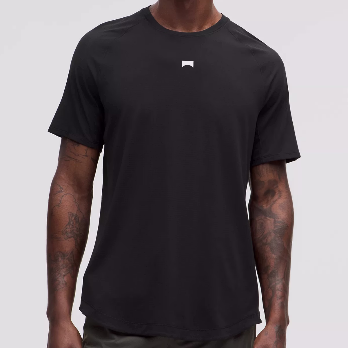 Torso shot of a man wearing a black tee shirt.