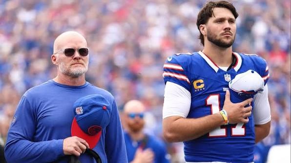 Sean McDermott en Josh Allen die vlak voor de start van de wedstrijd naar het volkslied luisteren.