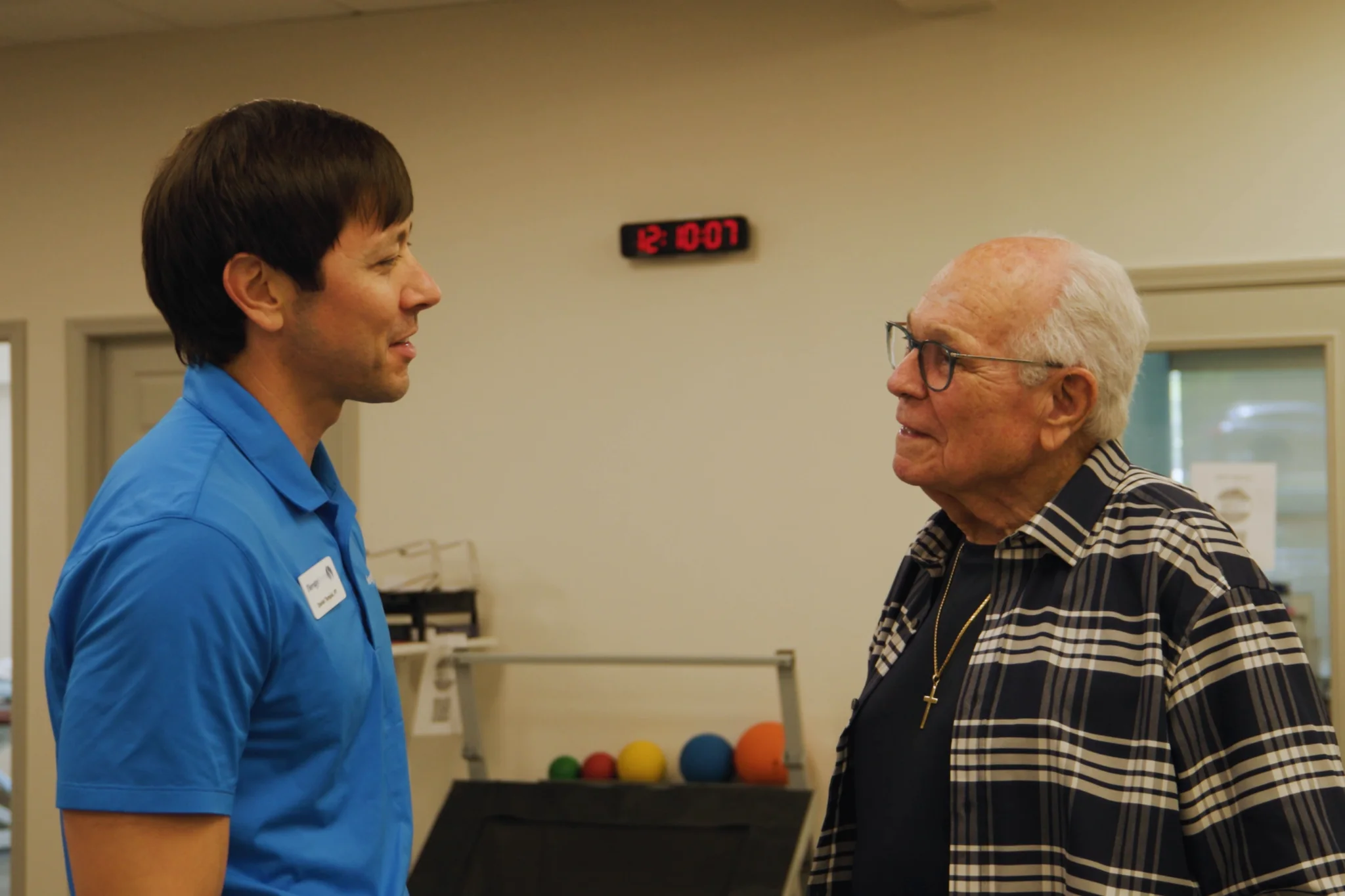 TherapySouth physical therapist talking with an older patient in the clinic