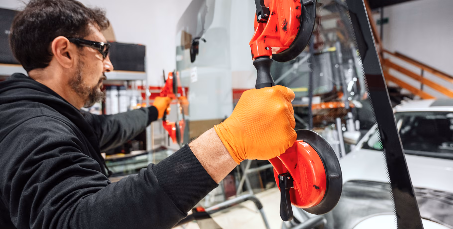 An autobody technician replacing a windsheild