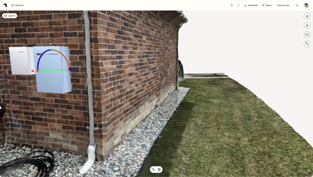 Polycam's 3D capture interface showing an exterior view of a brick building with white Enphase electrical equipment mounted on the wall. The interface includes a layers panel on the left and navigation controls, with a grassy area and gravel ground visible