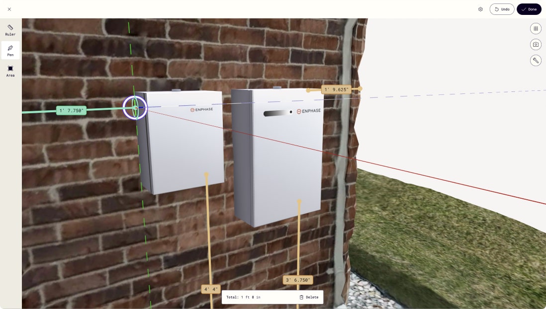 Polycam's measurement interface displaying the same brick wall with Enphase electrical equipment, now with active measurement tools showing precise dimensions. Green measurement lines and yellow measurement callouts are visible, with a measurement total of "1 ft 8 in" displayed at the bottom of the screen.