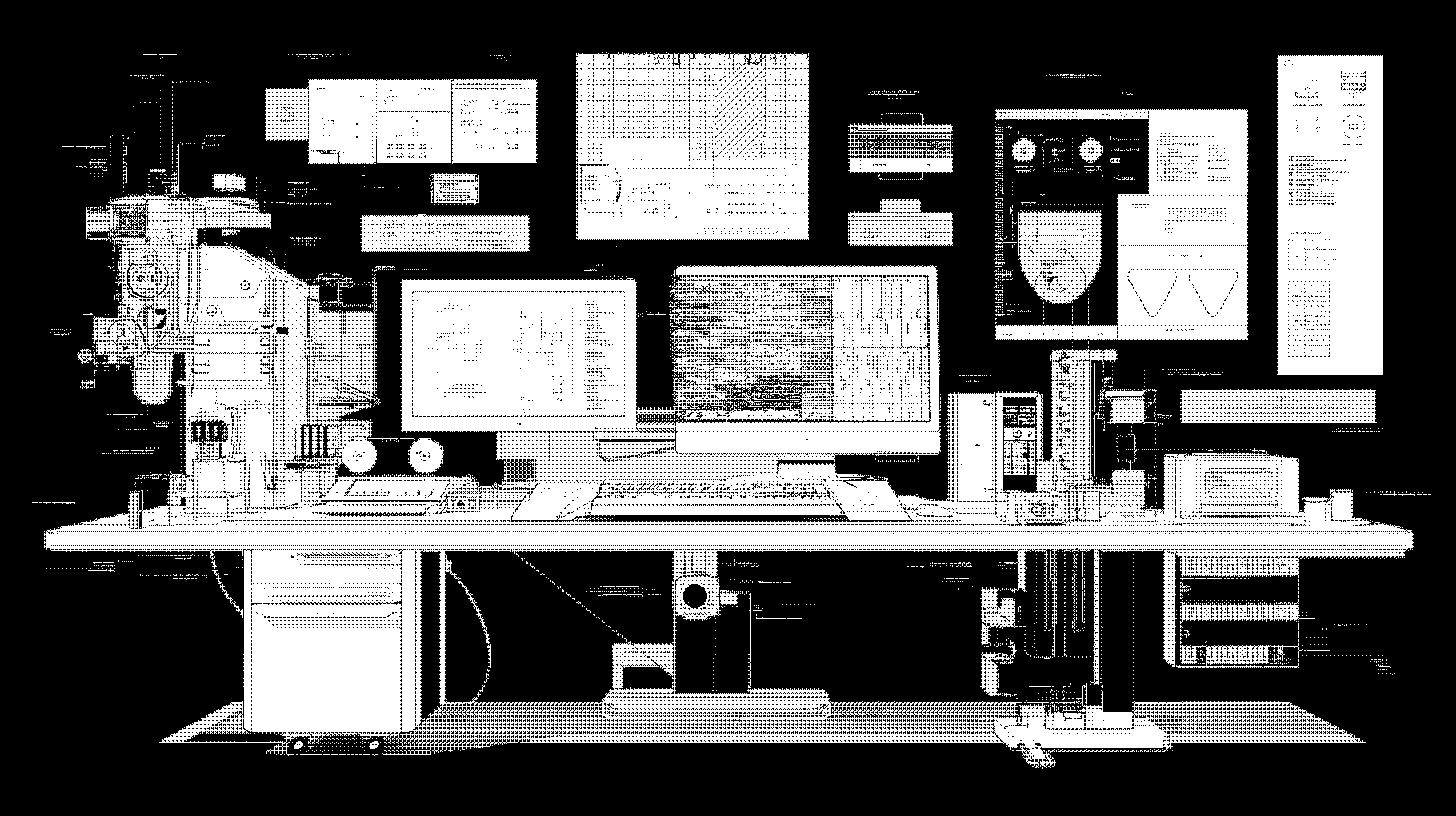 A laboratory setup with multiple scientific instruments and two computer monitors displaying data, charts, and schematics above a desk.