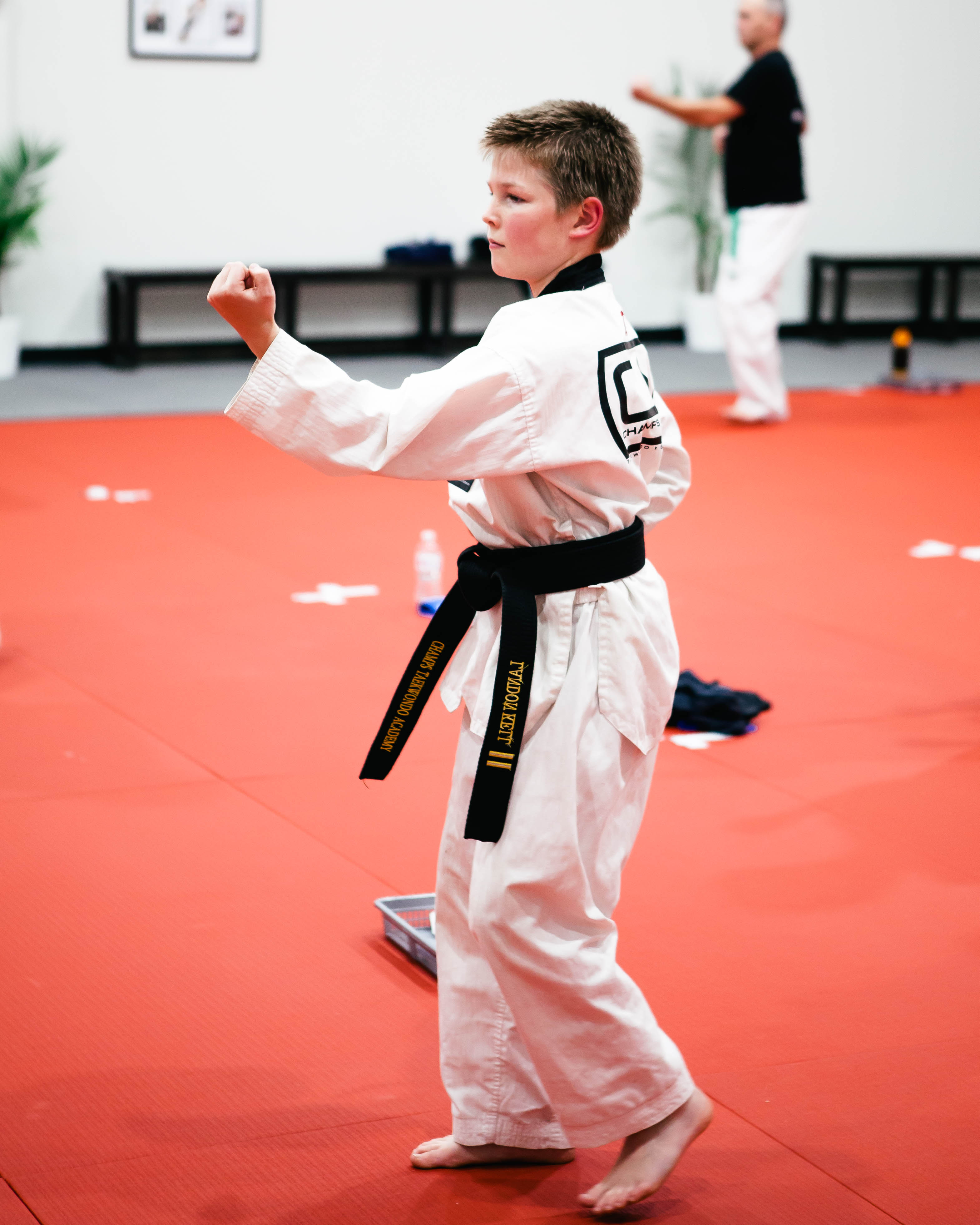 A kid practicing Taekwondo