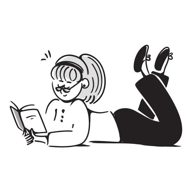 Girl laying down on the floor while reading a book.