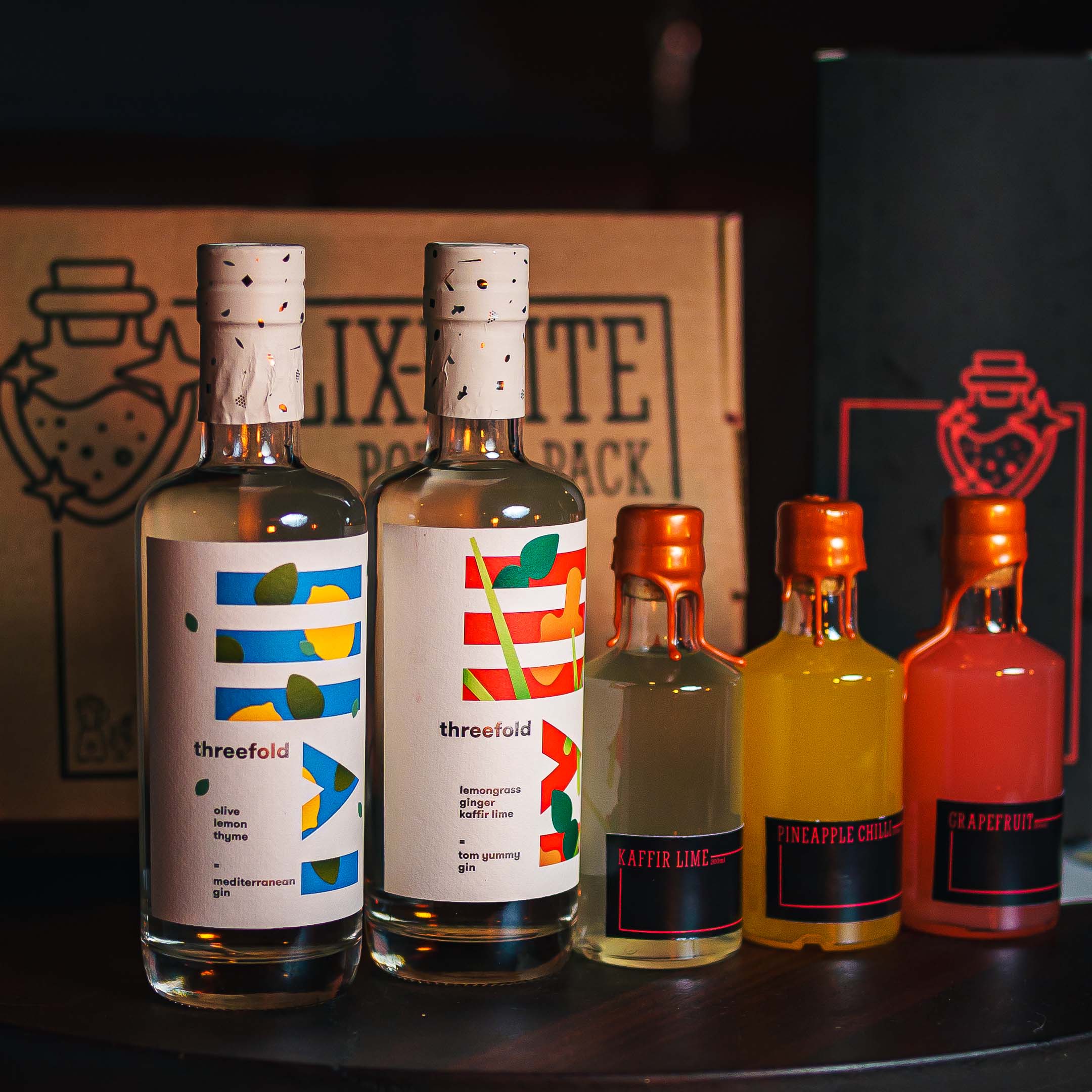 Two hands, raising a cocktail to one another