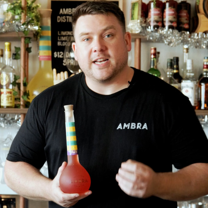 Two hands, raising a cocktail to one another