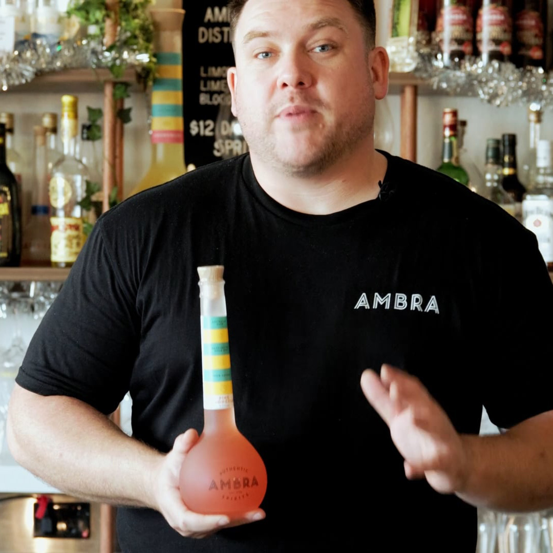 Two hands, raising a cocktail to one another