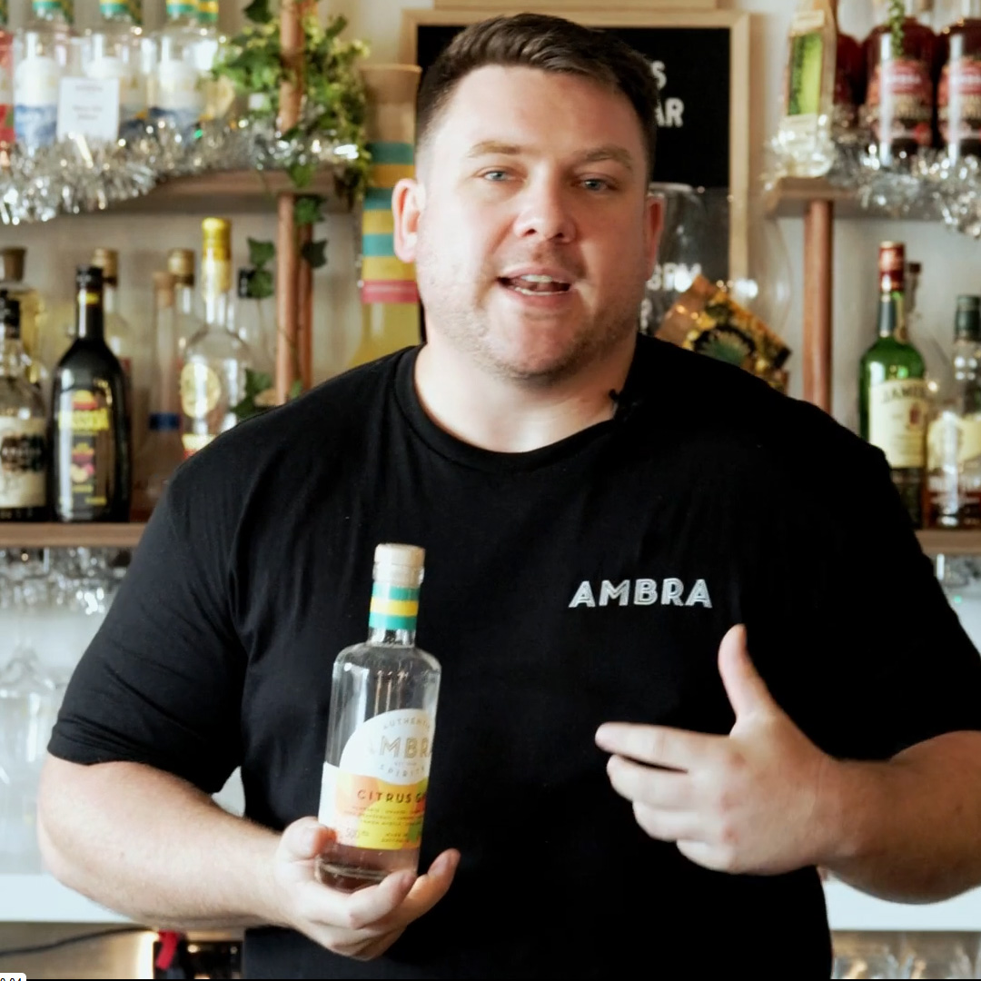 Two hands, raising a cocktail to one another