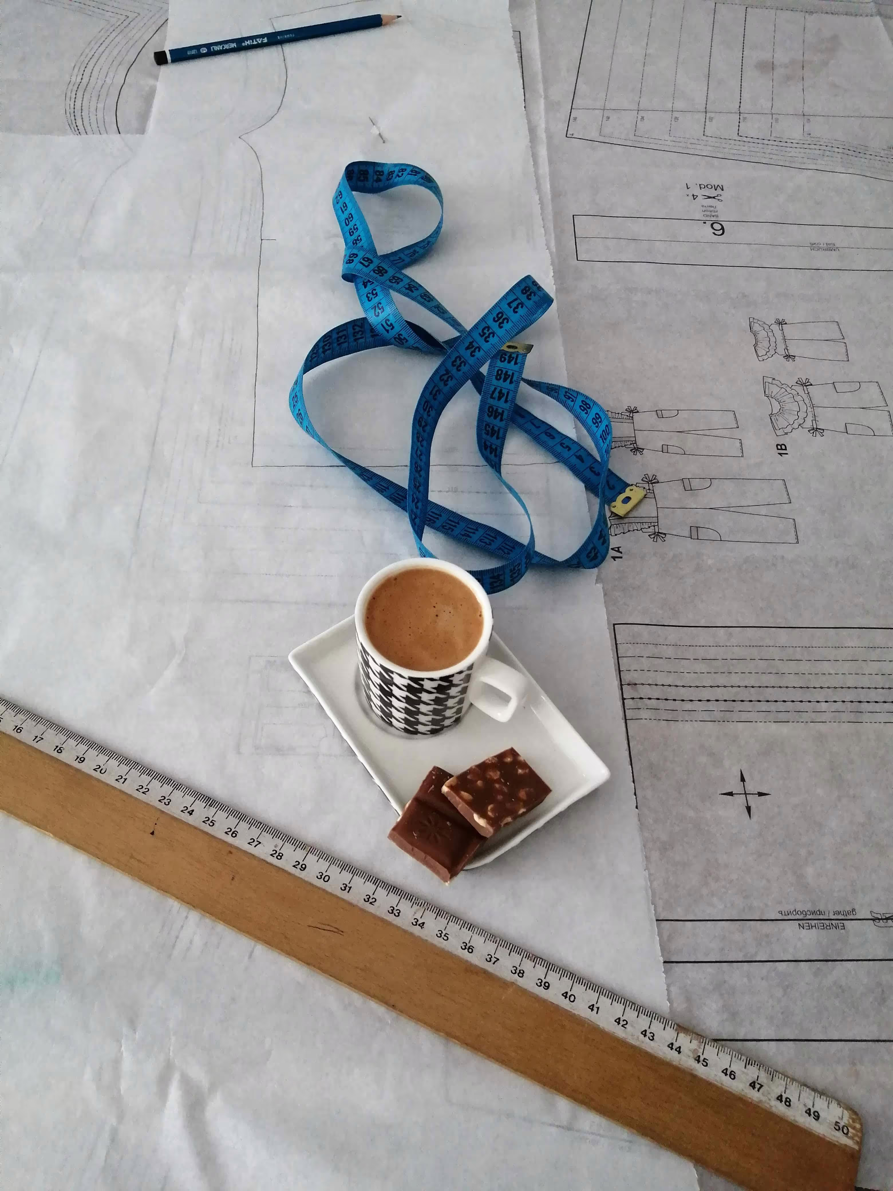 Tea and biscuit on a table placed on top of papers