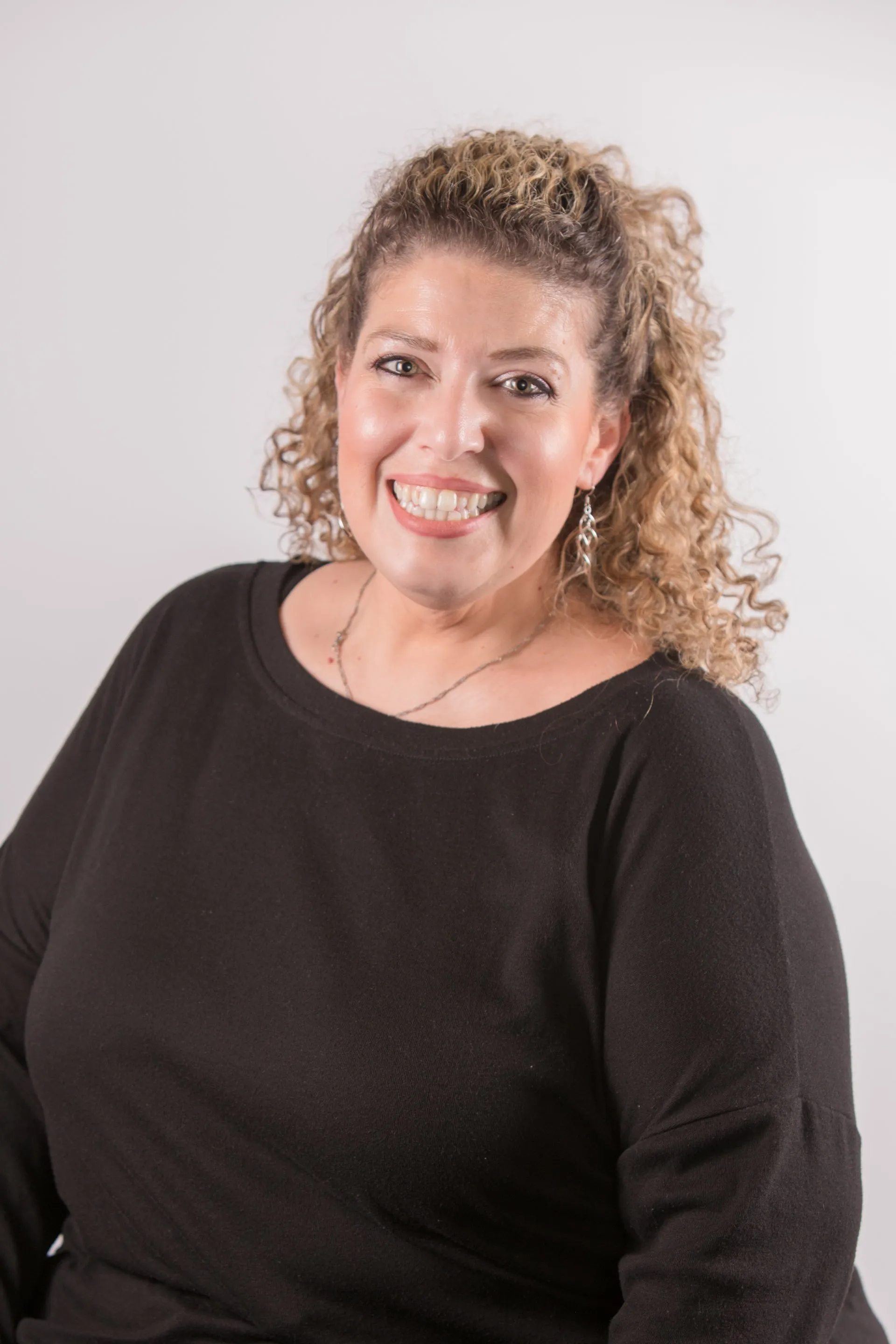 Professional headshot of Sarah LeBlanc, Director of Marketing at Jewett Construction, wearing a black blouse, smiling. She drives marketing and branding efforts, showcasing the company’s excellence and industry leadership.