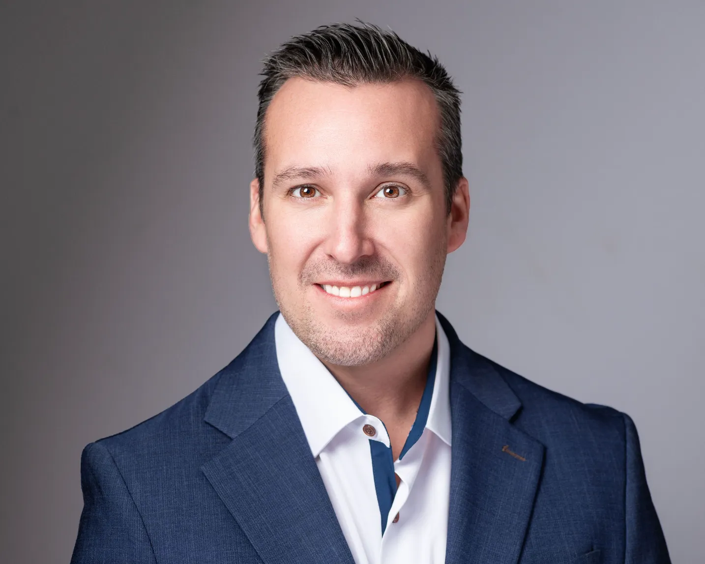 Professional headshot of Andrew Affronti, Director of Operations at Jewett Construction, wearing a white button-up shirt, and navy blue suit jacket. Andrew leads all project execution across Project Management and Field Operations.
