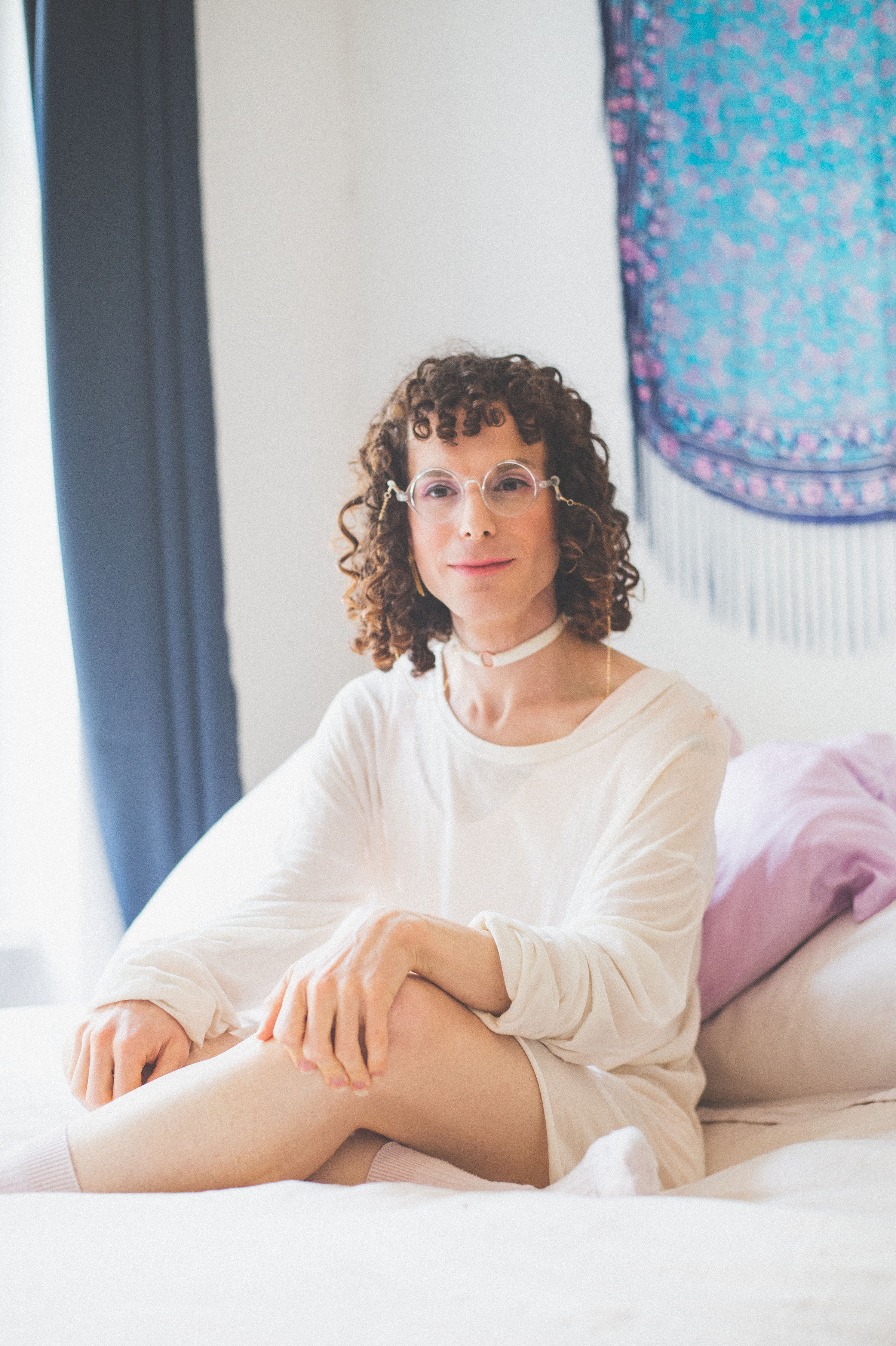Em sitting in bed looking ethereal and magic.