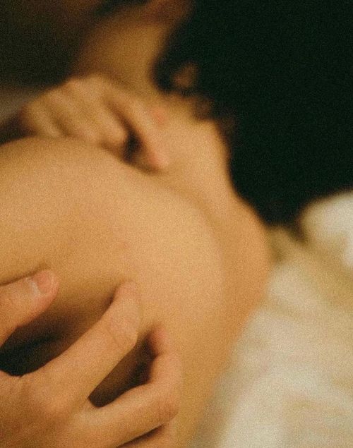 Someone caressing a loved ones bare shoulder.