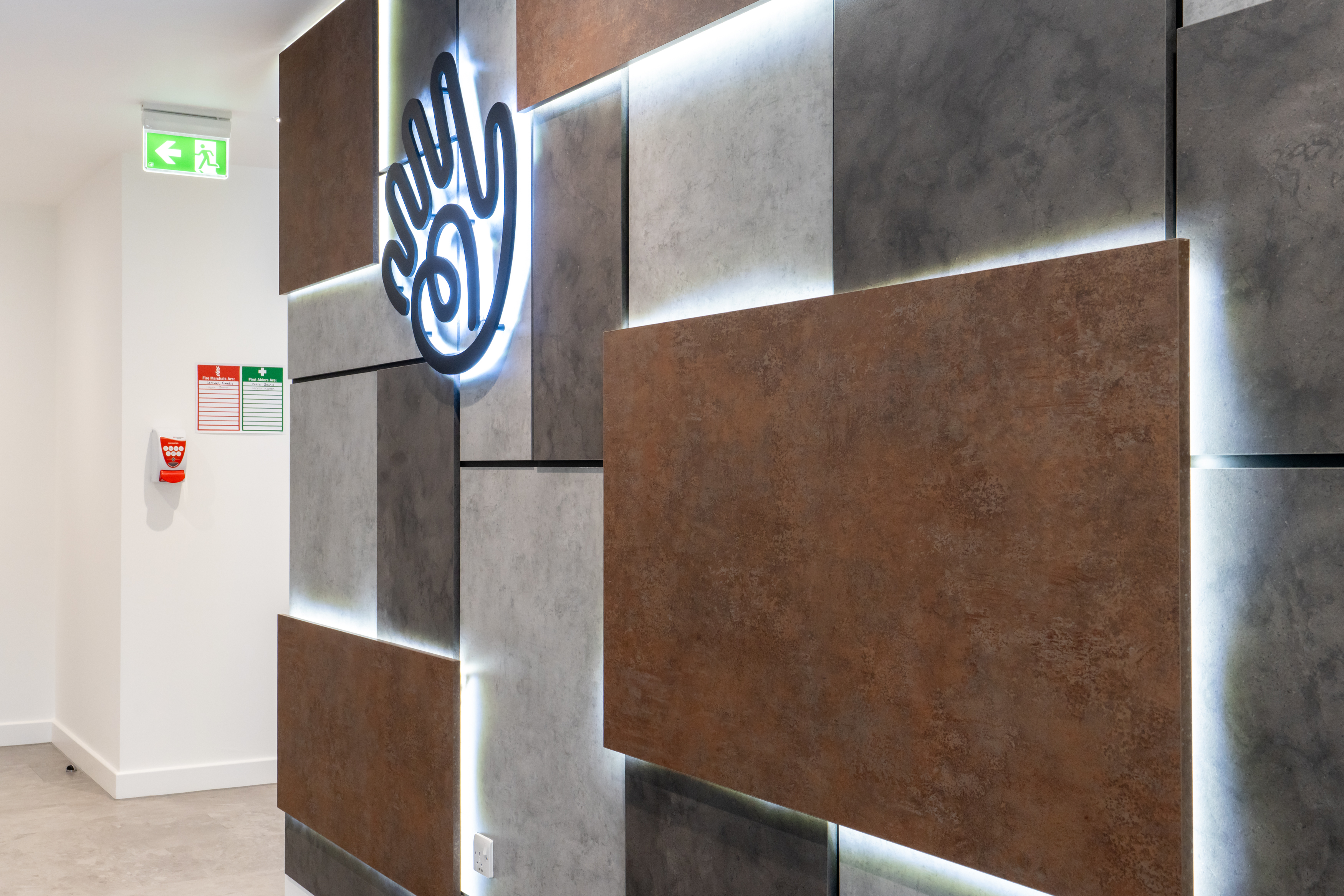 A closer view of the hand logo on the wall panelling.