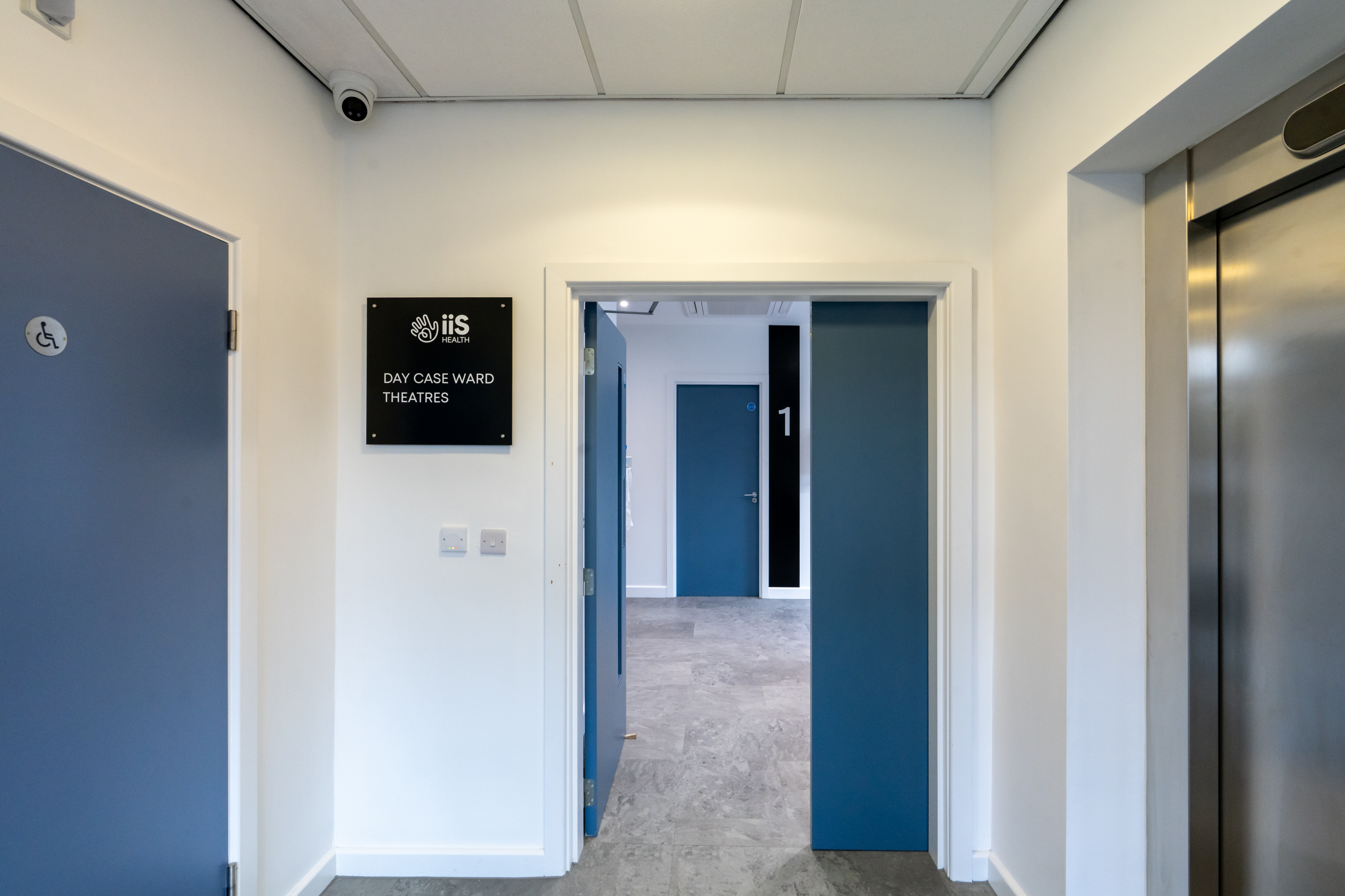 Main entrance to the hospital showing the entrance to the day case ward and showing a lift and disabled toilet.