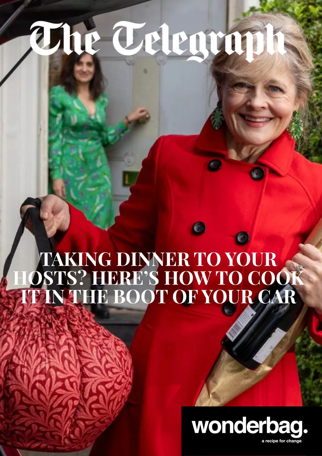 A smiling woman in a red coat holding a bottle of wine and a red patterned bag stands in the foreground, while another woman in a green dress opens a door in the background, with the headline 'Taking dinner to your hosts? Here’s how to cook it in the boot of your car' and branding for Wonderbag.