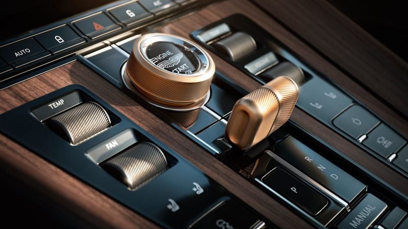 À l'intérieur comme à l'extérieur, on retrouve des touches en bronze anodisé dans ces Vanquish et DB12 Volante. Les boiseries sont en noyer sombre.