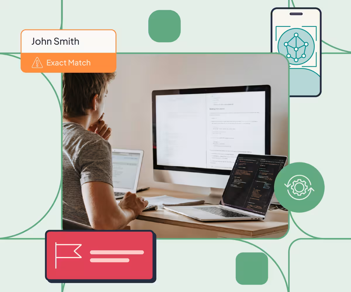 Image of a Man sitting at a desk looking at code on a laptop screen and a big monitor with illustrations of the Red Flag Alert product around it