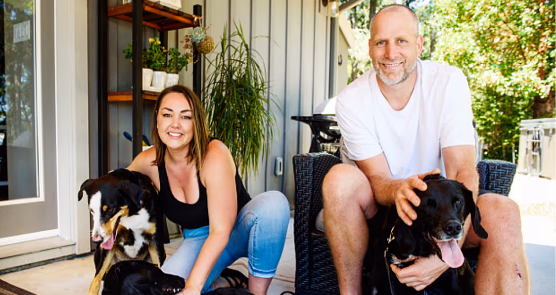 People sitting with their dogs