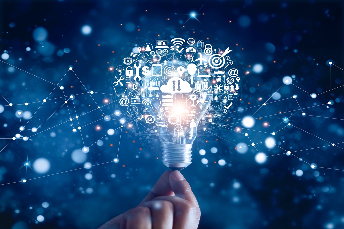 A hand holding a lightbulb surrounded by logos representing web development techniques in cyberspace.