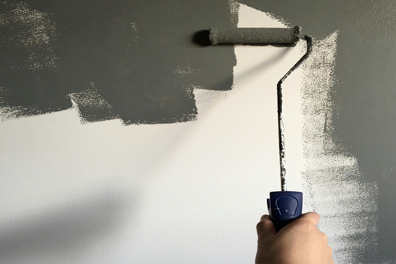 An image of a painter renovating a wall, mirroring a website redesign.