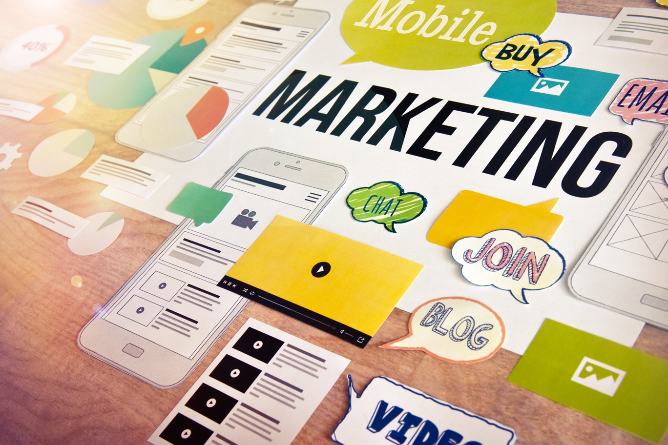 A closeup on a collection of marketing keywords and icons laid out on a table
