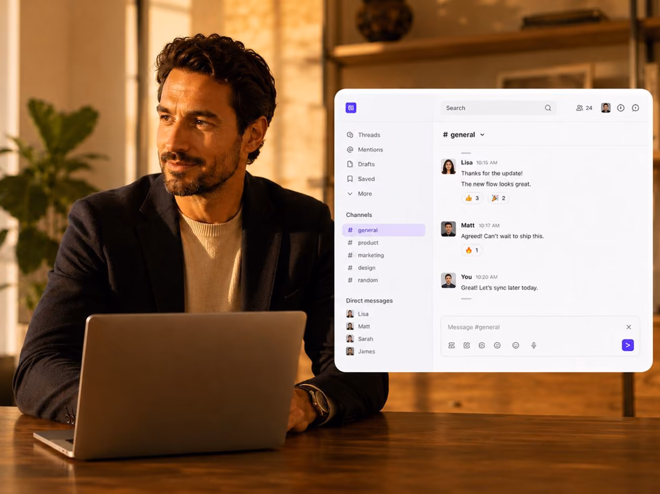 Man sitting at a table with a laptop, next to a screen showing a group chat in a messaging app.