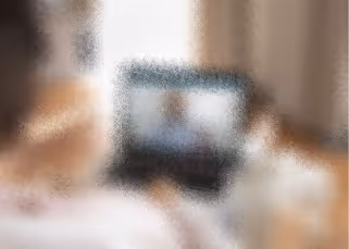 Blurred laptop computer on desk - modern home office workspace concept