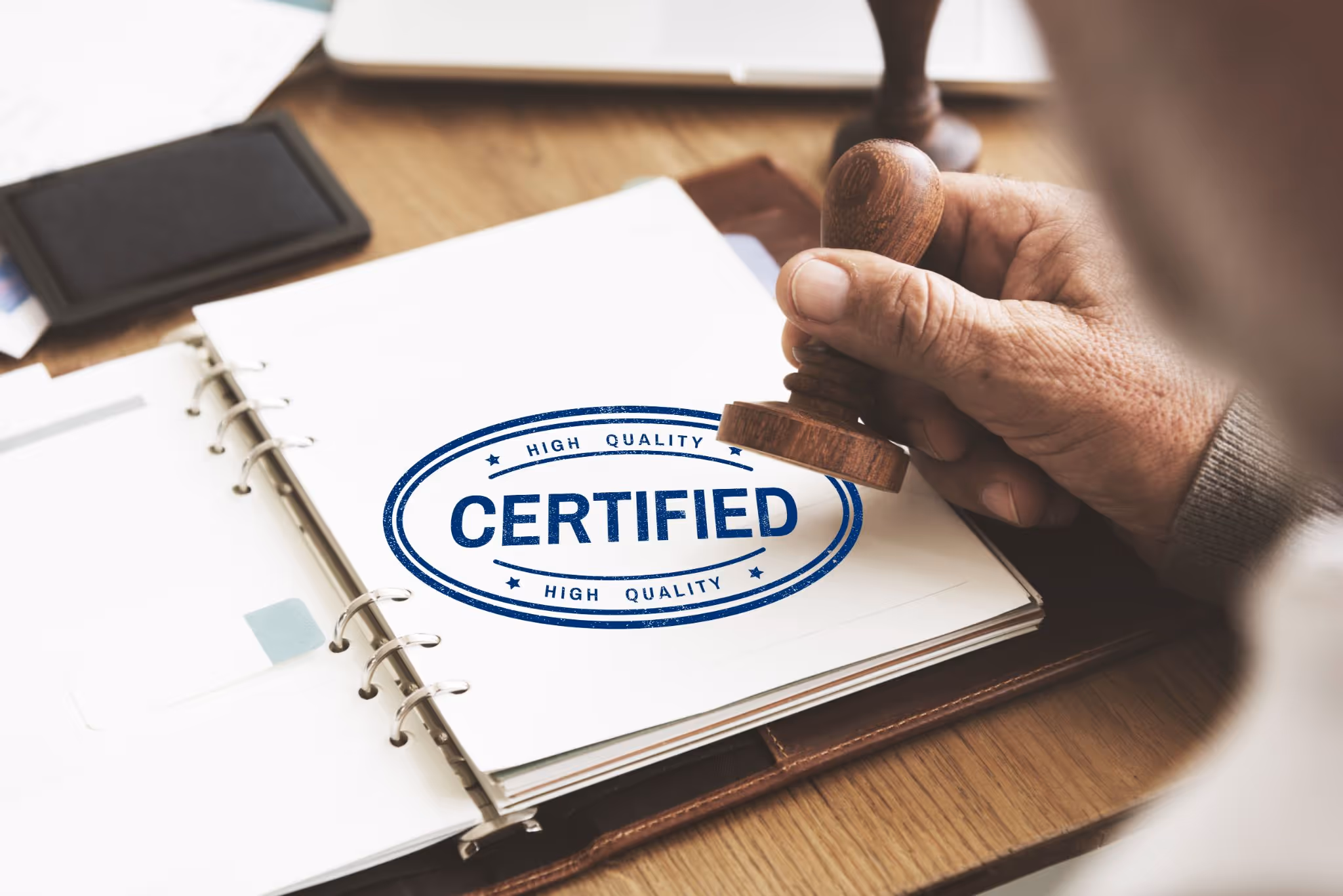 Hand stamping certified approval on document for medical weight loss certification