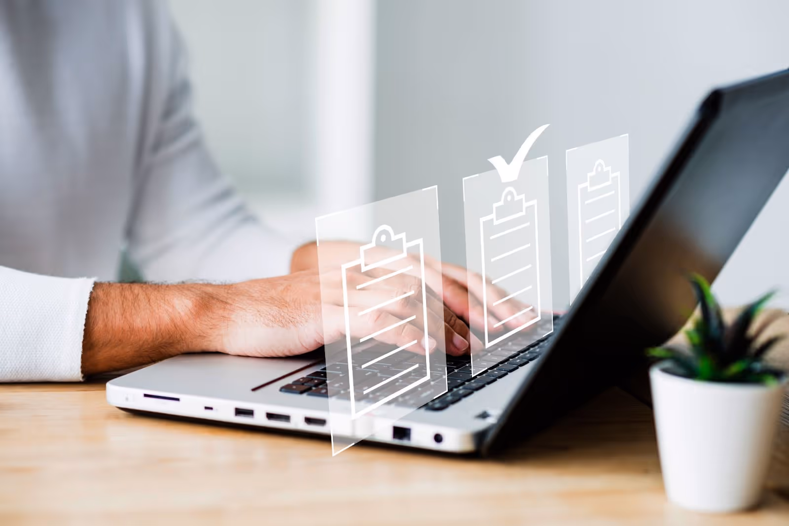 Business professional's hands typing on laptop with transparent growth charts and progress indicators overlay showing improvement metrics