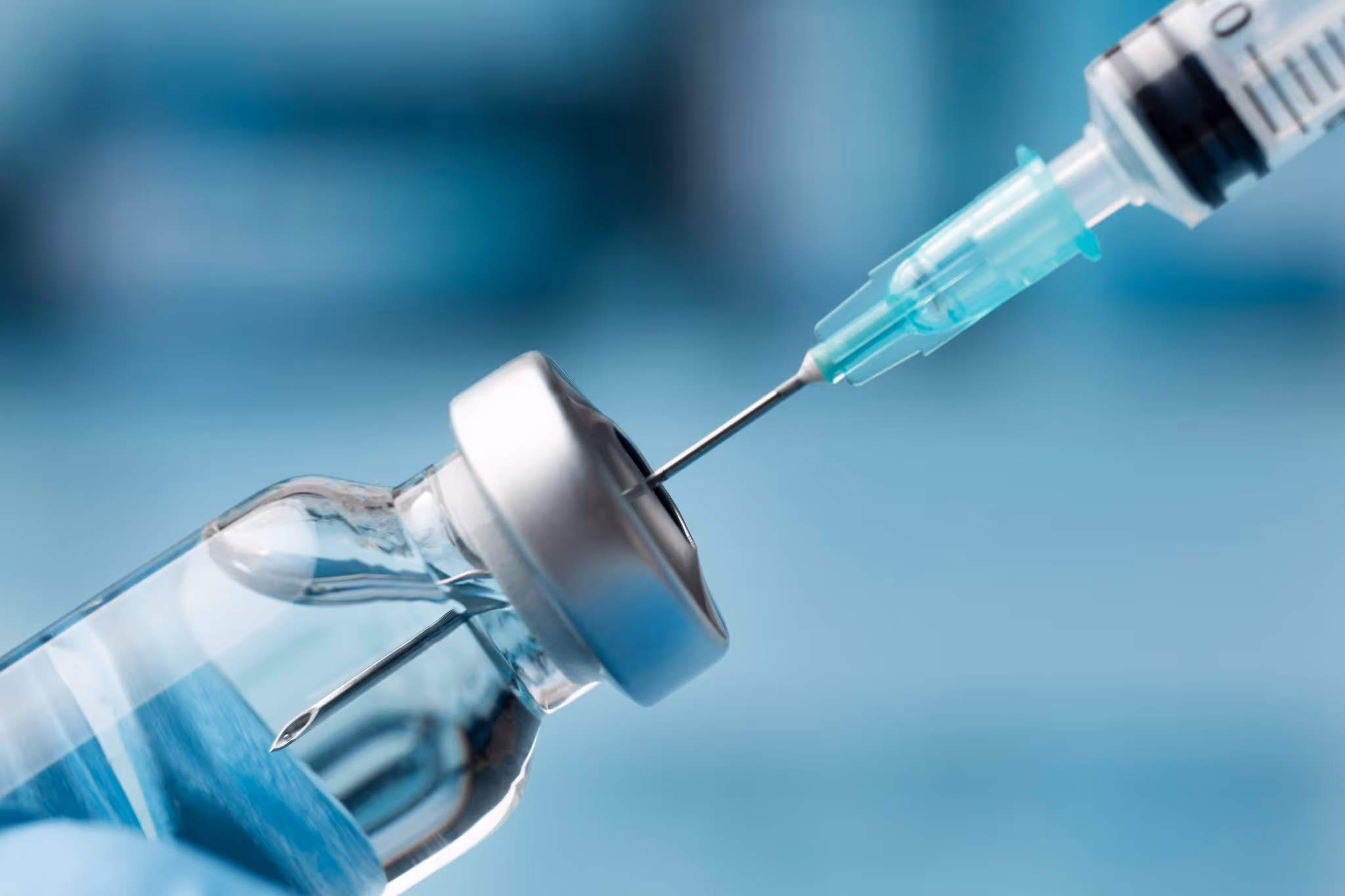Medical syringe drawing medicine from vial for weight loss treatment