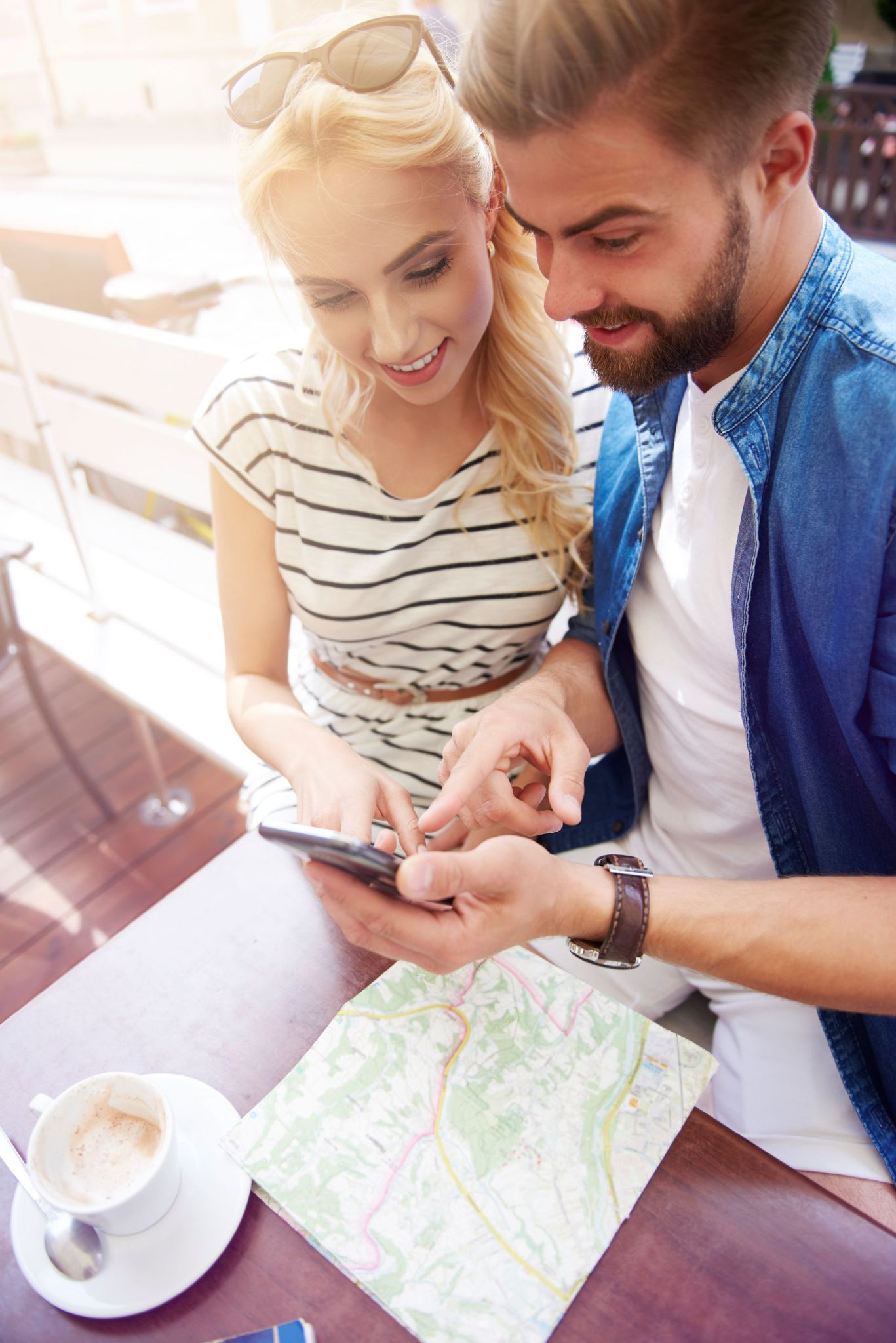 Young couple planning healthy lifestyle with map and smartphone consultation