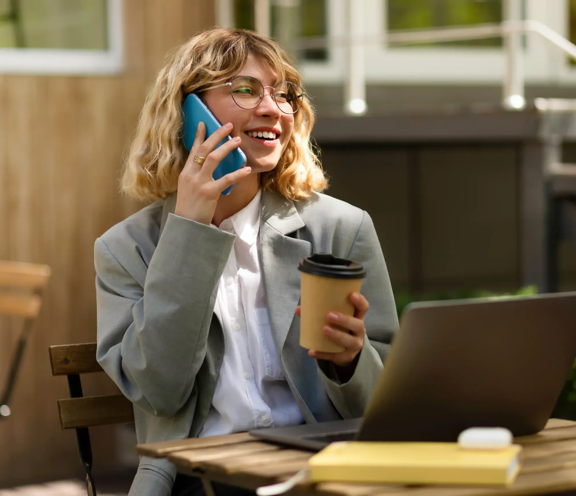 Smiling businesswoman’s call is answered 24/7 by Adaptify’s AI receptionist, eliminating after-hours voicemail.