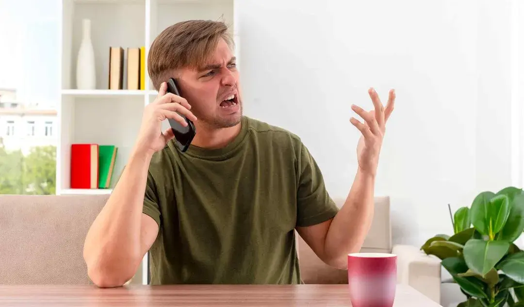 Frustrated homeowner stuck on hold with a generic call centre voicemail