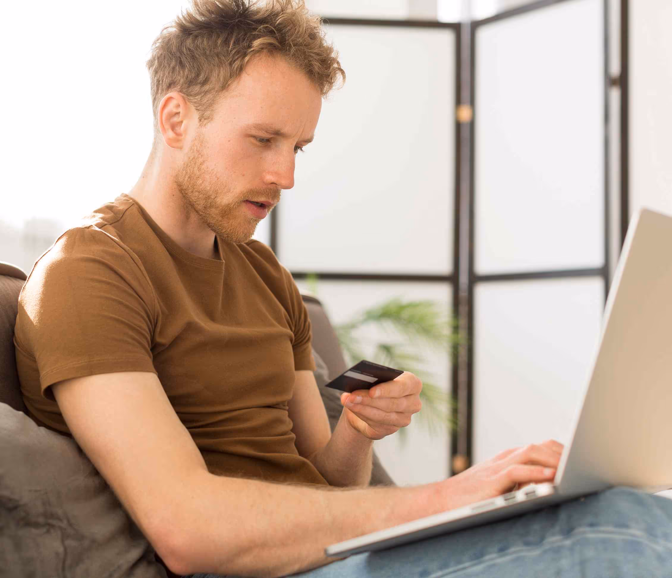 Customer renewing an HVAC maintenance plan online with credit card in hand
