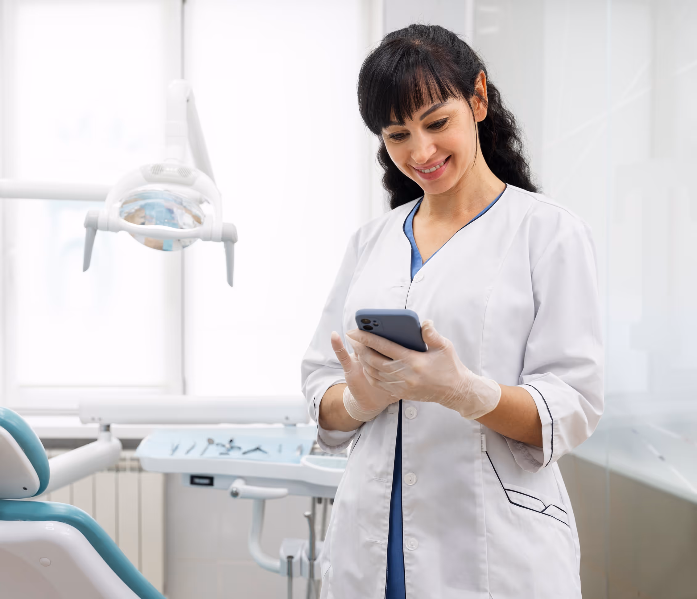 Dental assistant smiling at an Adaptify missed-call SMS that re-engages a patient