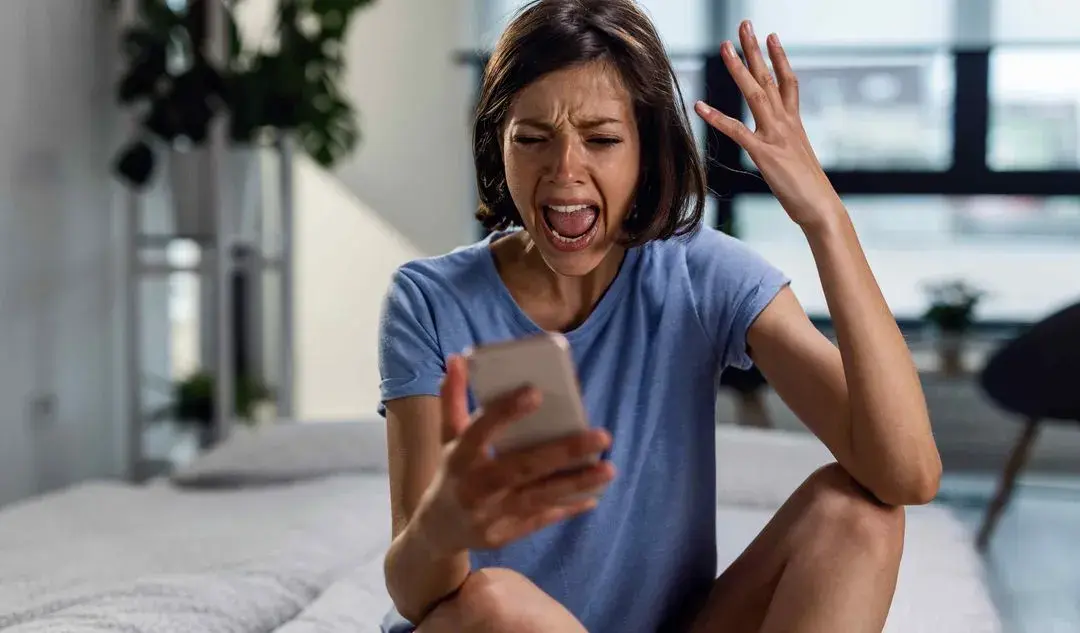 Angry patient on hold with voicemail, illustrating revenue lost without Adaptify dental answering