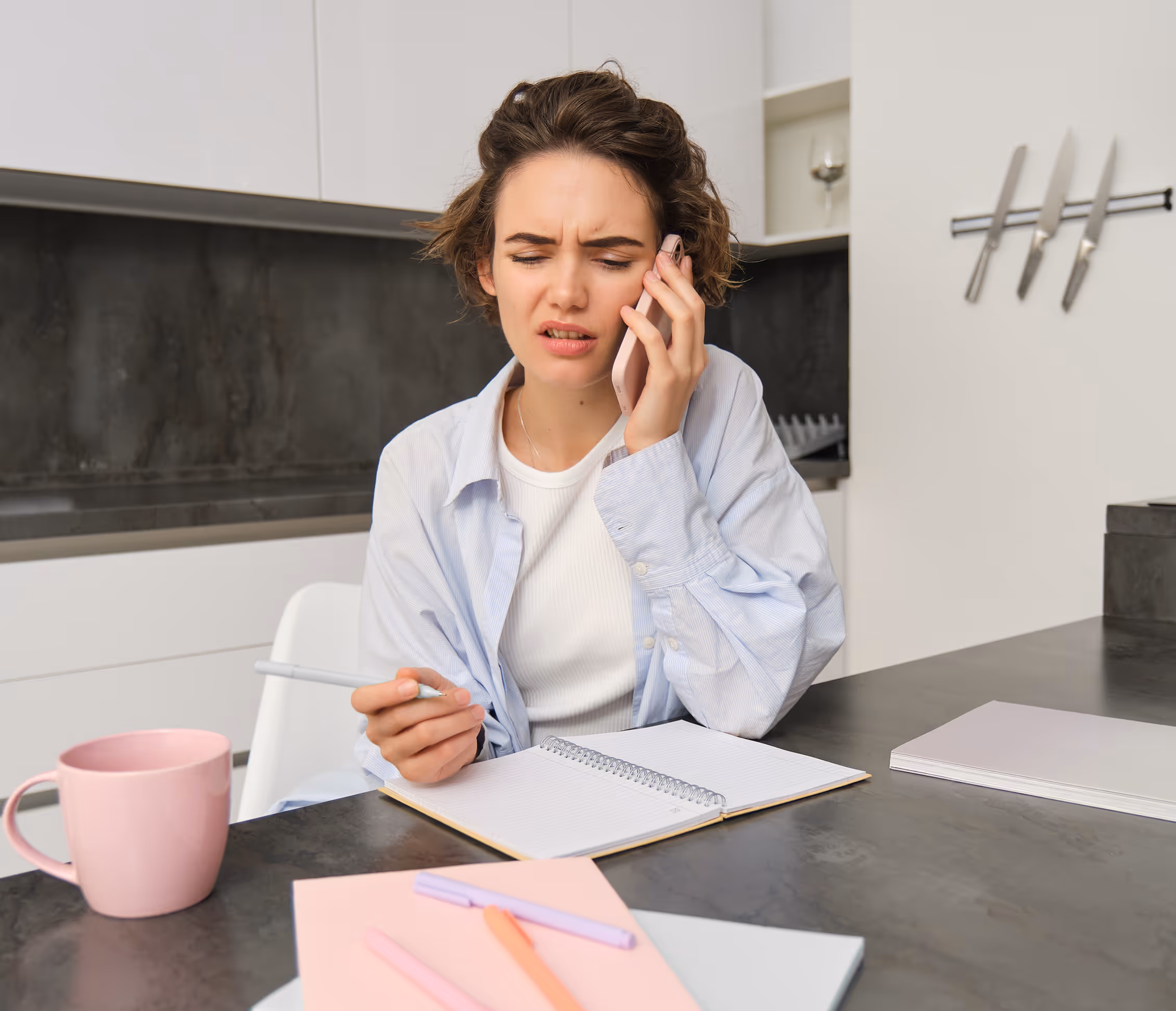 Woman with severe tooth pain phoning Adaptify’s 24/7 emergency dental answering service