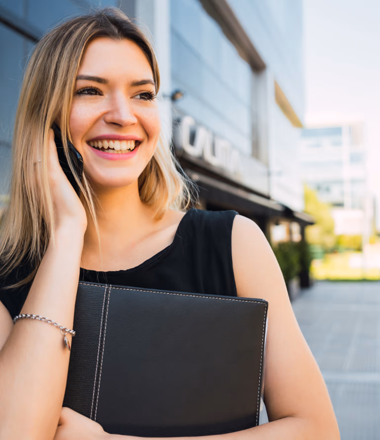 Smiling small-business owner on a phone call representing our AI answering service.