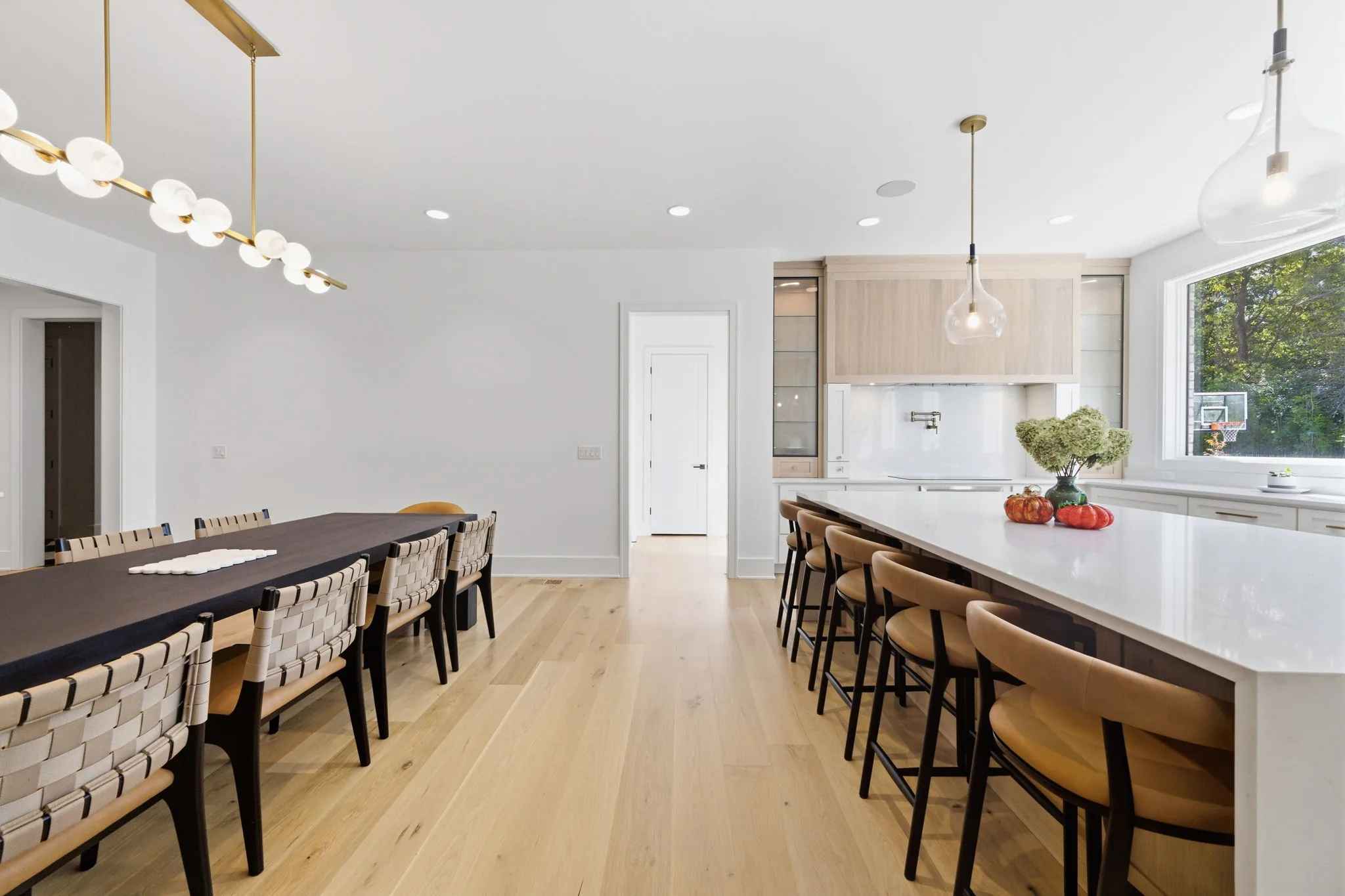 Kitchen with a waterfall island, seating for five, a wood range hood, and a pot filler