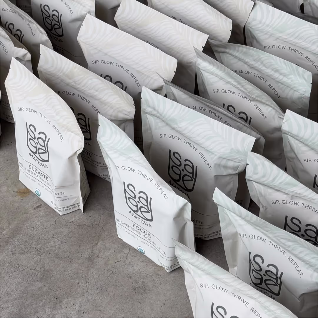 A photo of bags of Sage Matcha organized and lined up on the floor for distribution to vendors and e-commerce.