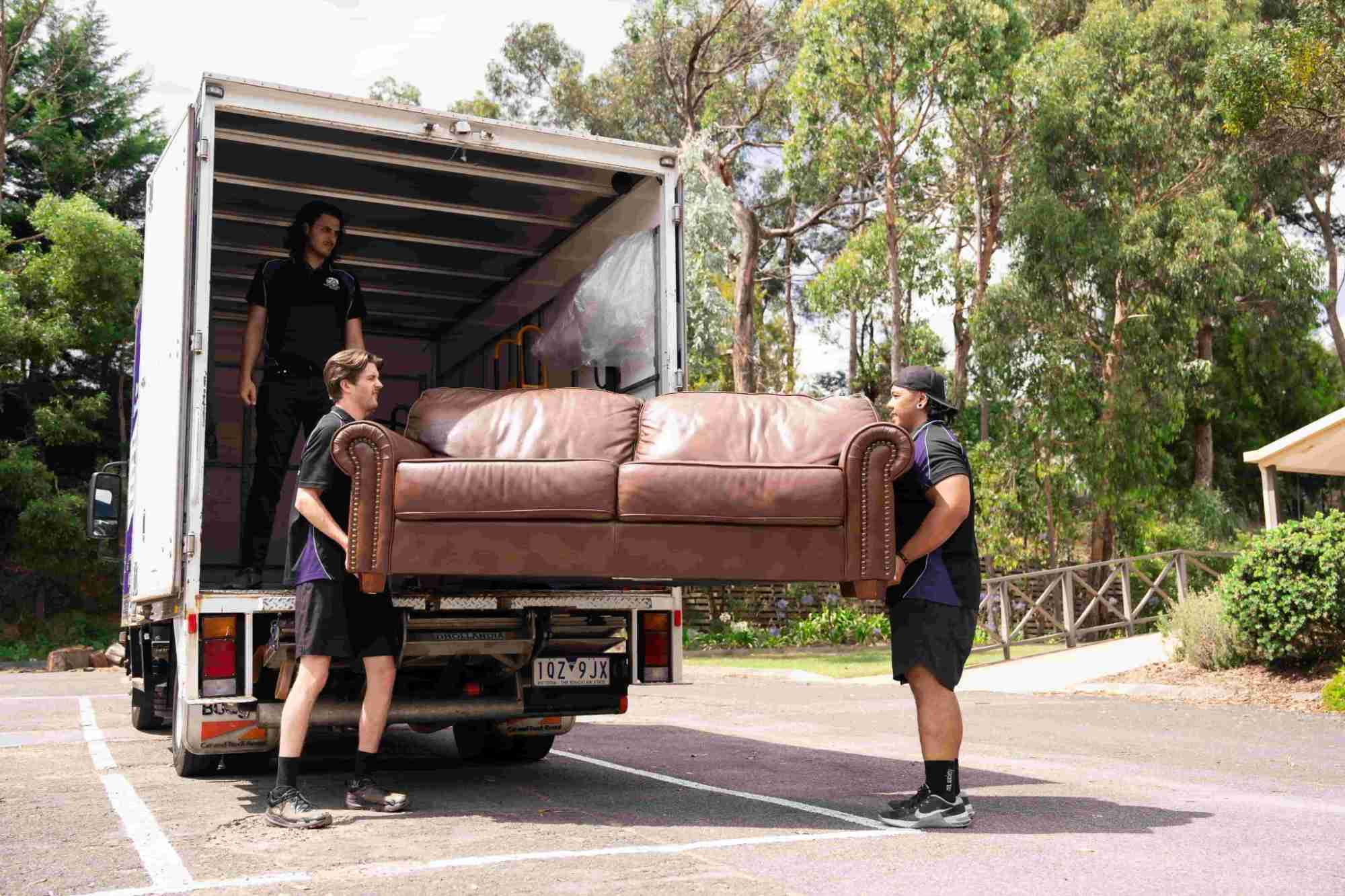 Jims Removals and Storage Team moving couch onto truck